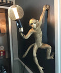 Dope Modern Resin Monkey Wall And Table Lamp With Hemp Rope Pendant Light For Home Decor White Finish mounted on a dark wall.