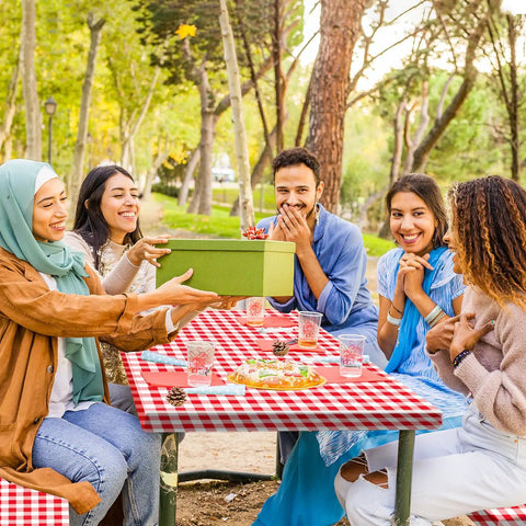 Three Piece Fitted Picnic Table Cover Set With Bench Covers Vinyl Tablecloth With Flannel Backing For 6ft Tables Outdoor Camping Red Checked 30 By 72 Inches Water And Oil Resistant Elastic Edges For A Snug Stayput Fit used at a picnic with people.