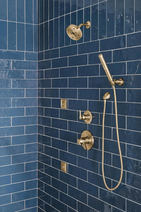 90 Degree Wall Elbow For Handheld Shower In Champagne Bronze Lumicoat Finish installed on blue tiled wall