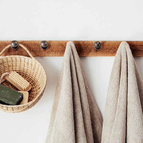 Wooden rack with towels and basket hanging on double-headed picture hangers nails set with small head pins for photos and frames 25 pcs