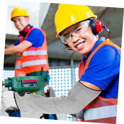Heavy Duty Cut Resistant Arm Sleeves With Thumb Hole Built Tough As Nails For Welding And Gardening Straight Up Anti Cut Guard Gear For Mechanics And Site Work Premium Forearm Sleeves worn by worker using tool.