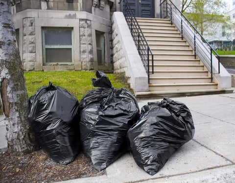 Three 55 gallon heavy duty trash bags with ties on sidewalk, extra large black liners, outdoor use, tear and puncture resistant
