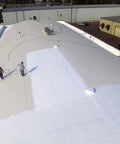 Workers applying Max Stretch Roof Coating White Elastomeric Sealant for Flat and Low Slope Roofs on a large commercial roof