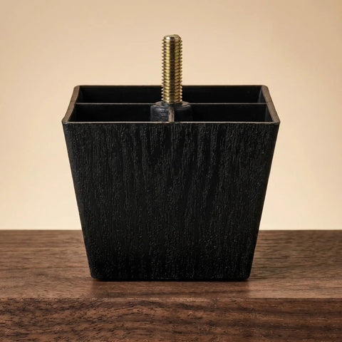 Close-up of an adjustable square furniture leg in black with threaded stud, part of the Adjustable Square Furniture Legs With Threaded Studs, 8-Pack No-Wobble Leveling Pads In Black Plastic And Metal, Easy Install For Sofas Tables Desks Cabinets And Media Consoles.