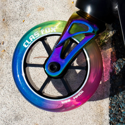 Top Shelf Pro Stunt Scooter Wheels 110Mm With Fast Rolling Abec 9 Bearings And Cnc Machined Aluminum Core Mid Rebound Polyurethane Shell Designed For Nailing Every Kick Flip Tricking Session Red Yellow Blue close-up of colorful 110mm wheel with CNC machined hub.