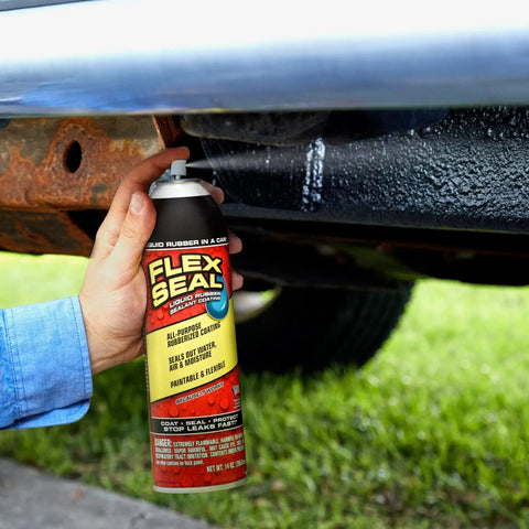 White 14 Oz Waterproof Rubber Spray On Sealant Coating That Stops Leaks Instantly Flexible After Drying Ideal For Gutters Wood RVs Campers Roofs Skylights Windows And More in use under a vehicle.