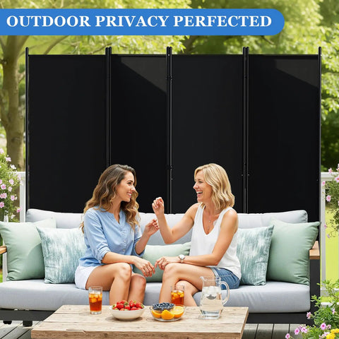 Six Foot Folding Privacy Screen With Lockable Wheels, 4-Panel Room Divider in black used outdoors, behind two women on a sofa