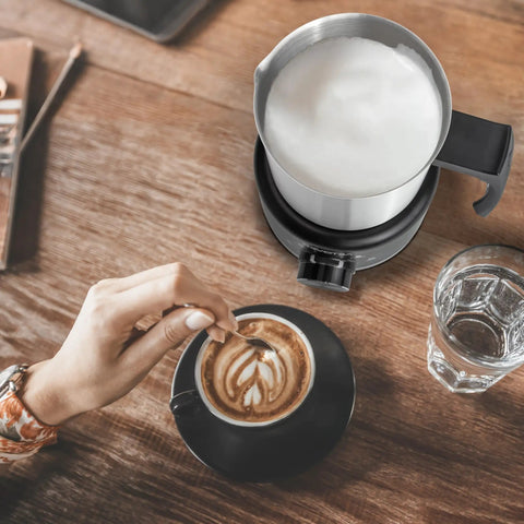 4 In 1 Milk Frother And Steamer 500ml Stainless Steel Electric Foam Maker With Hot Thick Foam Hot Thin Foam Hot Milk Or Cold Foam Barista Grade At Home For Lattes And Cappuccinos Easy Dial Controls And LED Indicators on wooden table