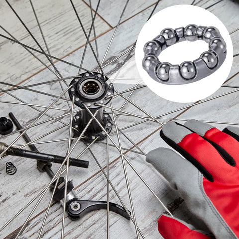 Four Pack One Quarter Inch Ball Bearings For Bicycle Crank Bearings Nine Balls Silver Bottom Bracket Bearings For Bike Axle Wheel Frame Repair Easy Install Fits Most Mountain Road Bikes in use on bicycle wheel with tools and gloves.