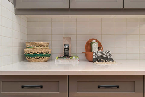 Kitchen countertop with decor and cabinets featuring 30 Pack Solid 5 Inch Cabinet Handles Matte Black Pulls For Kitchen Drawers And Cabinets.