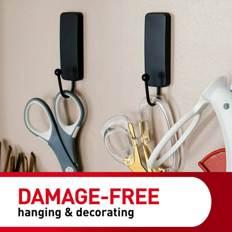 Medium Matte Black Wall Hook Set With Two Coat Hooks And Four Adhesive Strips, Damage Free Hanging Without Tools, Perfect For Home Decor, Holds Up To Three Pounds On Walls Doors Or Cabinets displaying holding scissors and tools