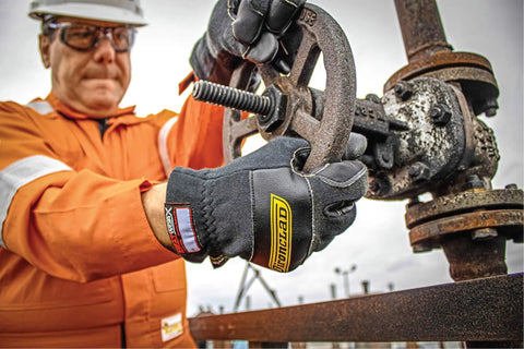 Person wearing Heat Worx Heavy Duty FR Fire Resistant Gloves For Handling Hot Stuff Up To 600°F, operating machinery.