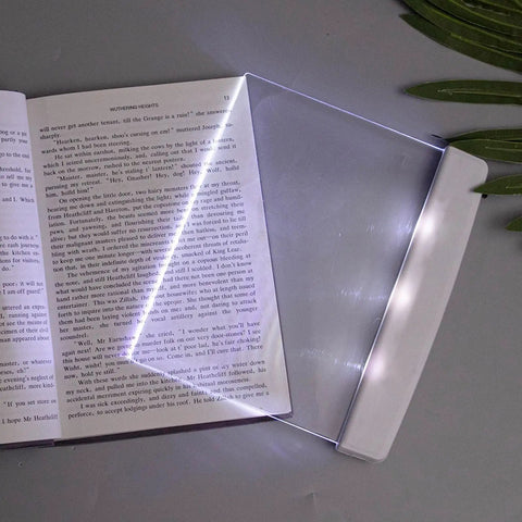 Flat Page Book Light With Clear LED Panel For Reading In Bed At Night Full Page Illumination Lamp Board placed on an open book