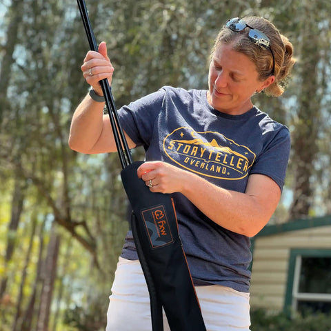 Person handling FXW stakes with Stakes Bag For Camping And Outdoor Use Stow And Carry Dog Pen Stakes With Ease Heavy Duty Travel Case Compatible With All Brand Stakes Keeps Gear Neat In RVs And Campgrounds While You Roll.