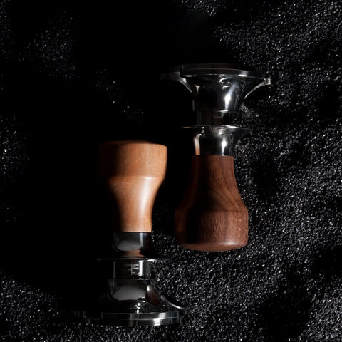 Top Shelf Adjustable Coffee Tamper With Smooth Flat Base Stainless Steel Barista Tool For Your Daily Grind Custom Size Powder Hammer Heavy Duty Kitchen Game Changer Gray, featuring two wooden handled tampers on a dark surface.