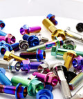 Multicolored Beast Titanium Flanged Hex Head Bolt M6 x 1.0 x 12mm, 6AL4V Aerospace Grade Ti Fasteners on white surface