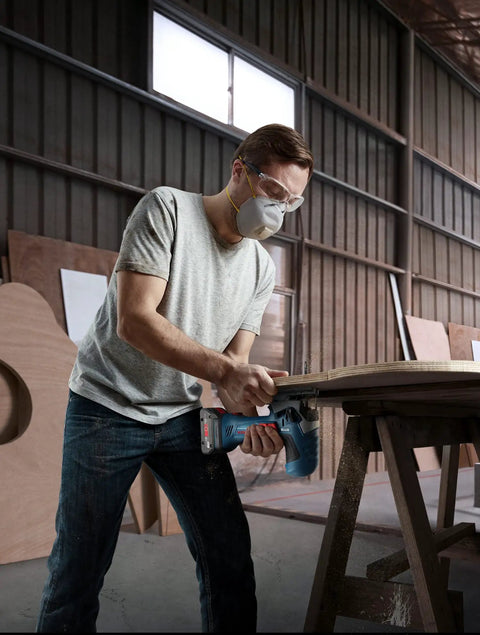 Man using Real Deal 18V Cordless Jigsaw Packing Brushless Muscle And Quick Swap Blades for curved cuts in wood.