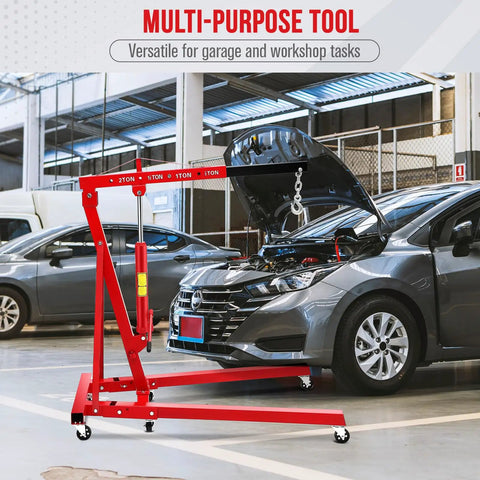 Two Ton Folding Hydraulic Engine Hoist With Telescopic Boom And Six Casters Portable Engine Crane shown lifting car hood in garage
