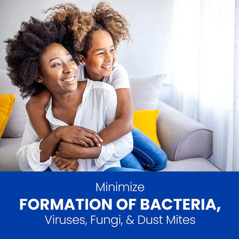Two people smiling on a couch with text emphasizing minimizing bacteria, viruses, fungi, and dust mites.