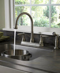 Glenfield 2-Handle High Arc Kitchen Faucet With Side Sprayer In Stainless Steel ADA Compliant Ceramic Disc Valve Tech Tri-Flow Water Control Built To Last No-Fuss Cleaning, mounted on a kitchen sink.