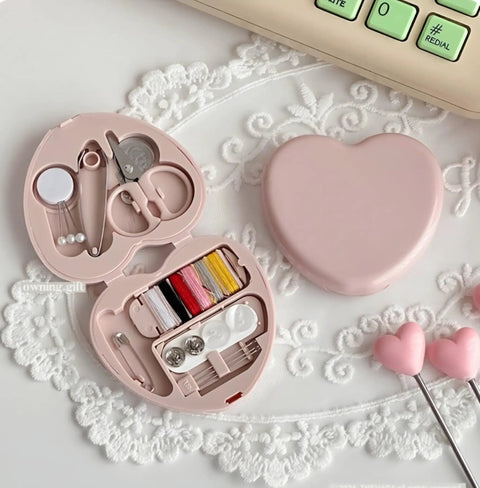 Compact Travel Sewing Kit Two Pack Featuring Adorable Heart Shaped Cases Pink And Blue with sewing essentials inside open pink heart case.