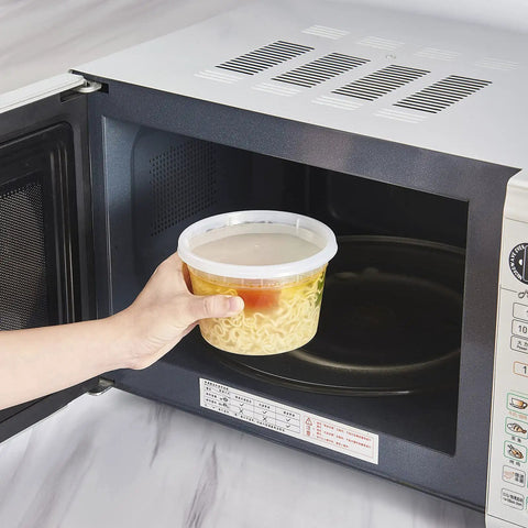Person placing 16-Ounce To-Go Food Storage Containers With Lids, BPA Free, Leakproof Microwave Safe inside microwave