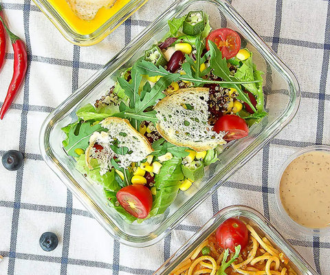 Glass container filled with fresh salad, part of Eight Pack 30 Oz Glass Meal Prep Containers With Airtight Lids Glass Food Storage.