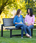 Two people seated on Outdoor Convertible Bench To Table In Seconds 55 Inch Harbor Gray Weather Resistant Polystyrene Slats