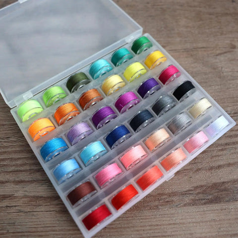 Top Shelf 72 Piece Sewing Thread Kit With 36 Vibrant Polyester Shades And Matching Bobbins displayed in clear case.