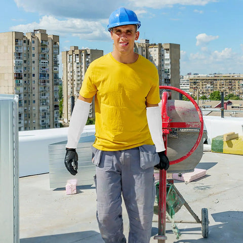 Built Tough Cut Resistant Forearm Sleeves Featuring Sweat Wicking HPPE And Reinforced Fiberglass Weave worn by worker at construction site.