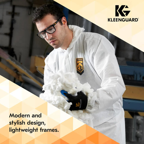 Person wearing Maverick Eye Protection Glasses With Clear Anti Glare Lenses, Black Frame And Orange Tips, working with material.