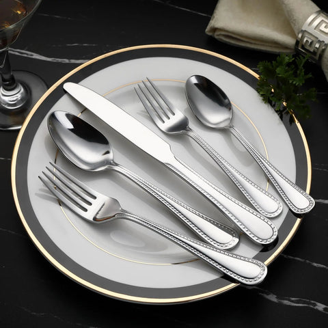 Heavy Duty Stainless Steel Flatware Set, 20 Piece Silverware Service For Four, on elegant plate with pearl edge design.