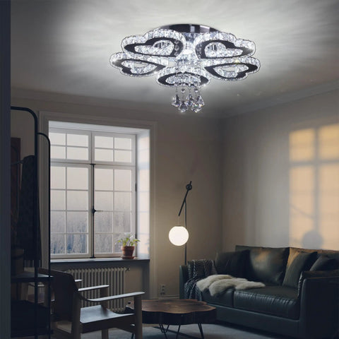 5 Heart Ring Crystal Chandelier LED Ceiling Light Fixture Stainless Steel Pendant Lighting in modern living room with sofa.