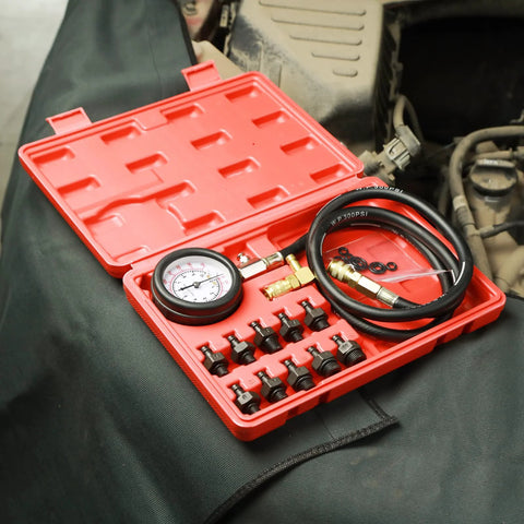 Oil pressure tester kit with 0-140 PSI gauge in red case, hoses and fittings