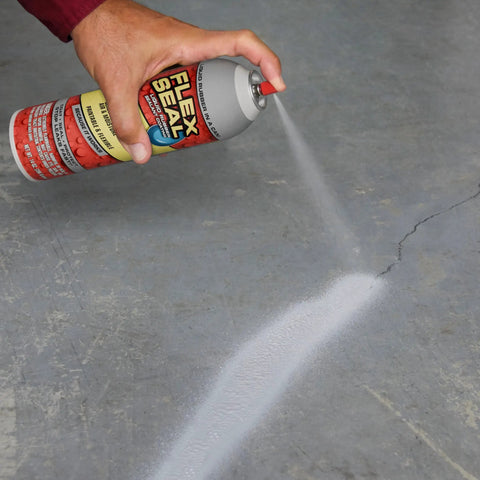 Applying white 14 oz waterproof rubber spray on sealant coating that stops leaks instantly flexible after drying ideal for gutters wood RVs campers roofs skylights windows and more on a crack.