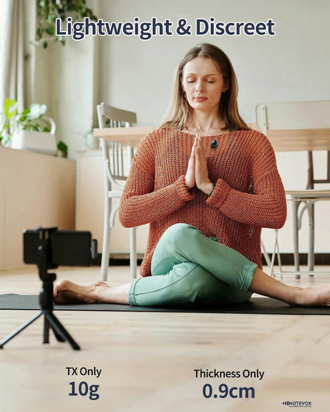 Woman meditating indoors with Wireless Lavalier Microphone For iPhone With AI Noise Reduction on sweater, phone recording setup.