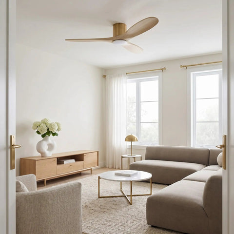 Slick Fifty Two Inch Hugger Ceiling Fan In Burnished Brass With Three Washed White Oak Blades bringing a cozy vibe to a modern living room.