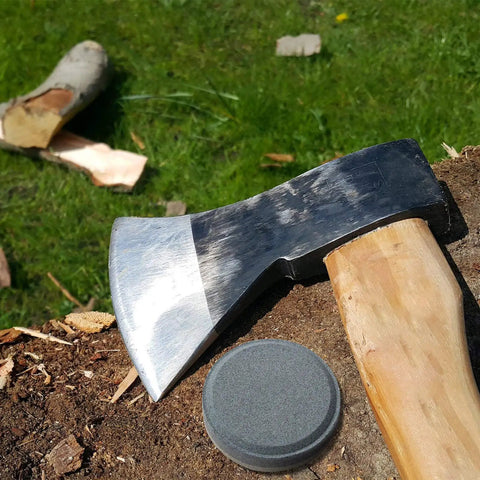 Axe with wooden handle beside whetstone on tree stump, Axe File Sharpener Set Pro Grade With 120 And 240 Grit Whetstone.