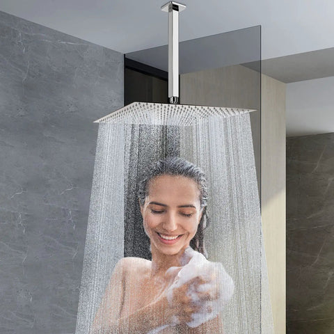Woman enjoying water flow from rain shower head with arm and square ceiling mount, 16 inch stainless steel chrome finish, full body coverage.
