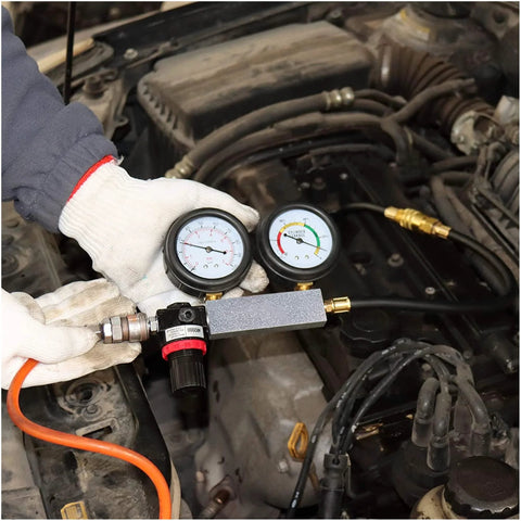 Automotive dual-gauge cylinder leak-down tester kit by Amazon, connected to car engine with orange hose.