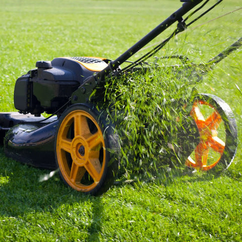 Lawnmower cutting grass with orange wheels for garden maintenance
