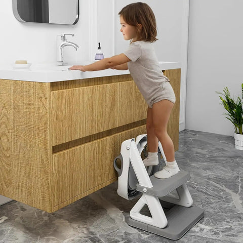 Child using Super Secure Toddler Potty Ladder And Training Seat With Memory Foam Cushion Non Slip Base to reach sink.