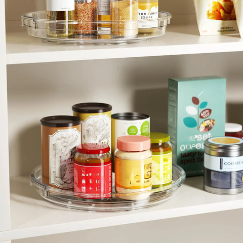 Smooth As Butter 4 Pack Lazy Susan Turntables on shelf, clear plastic rotating trays with jars, spices, and condiments.