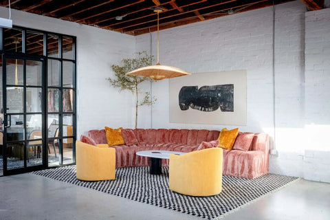 Totally Main Character Energy One Light Pendant Ceiling Light Fifty Two Inches Wide Vintage Gold Leaf Metal Dome Shade Hanging Lamp styled above a modern living room.