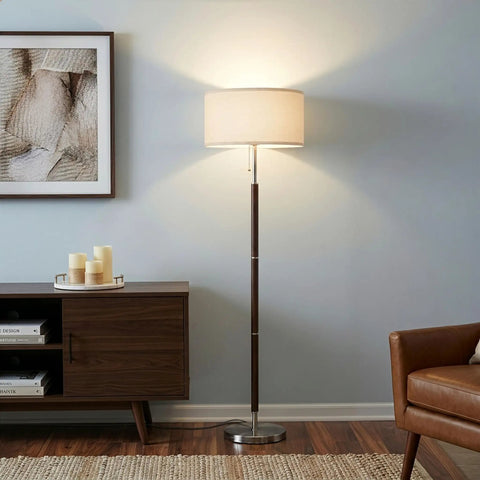LED Floor Lamp With Walnut Wood Finish And Drum Shade Mid Century Modern Style For Living Room Office And Bedroom Decor Tall Standing Lamp For Modern Homes next to a sofa and credenza.