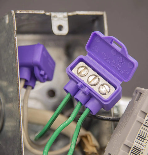 Close-up of AlumiConn Wire Connectors 2500 Pack Purple Electrical Aluminum Copper Wiring Repair Kit in a junction box.