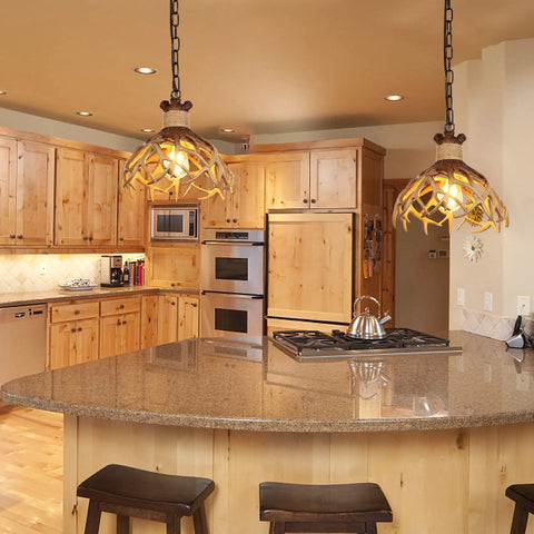 Rustic Deer Antler Pendant Ceiling Light With Aged Iron Accents illuminating a kitchen island, brown finish, farmhouse style