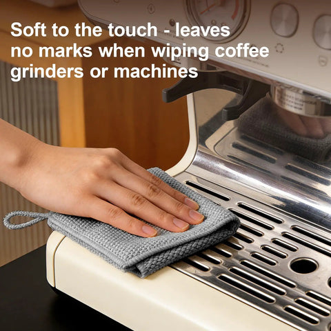 Hand using grey towel from Four Pack Microfiber Coffee Cleaning Towels Set 12x12 Inches With Hanging Loop on espresso machine