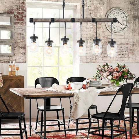 Dining room with Boss Gold Farmhouse Chandelier With Six Lights, modern industrial style, over rustic wooden table.