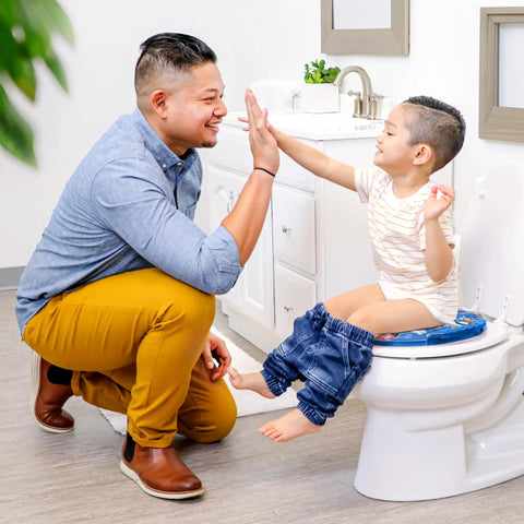 Toddler Potty Training Seat With Plush Removable Pad And Sturdy Grip Handles Fitting Regular Or Elongated Bowls Quick Wipe Down Design Super Comfy Setup Getting Little Tykes Cool With The Big Toilet in use with a child.